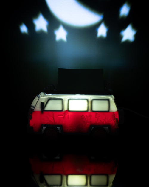 Toy van with a green roof under a crescent moon and stars projection on a dark background. Camping bus table lamp glowing retro van night light unique bedroom decor travel lover gift adventurer home decor