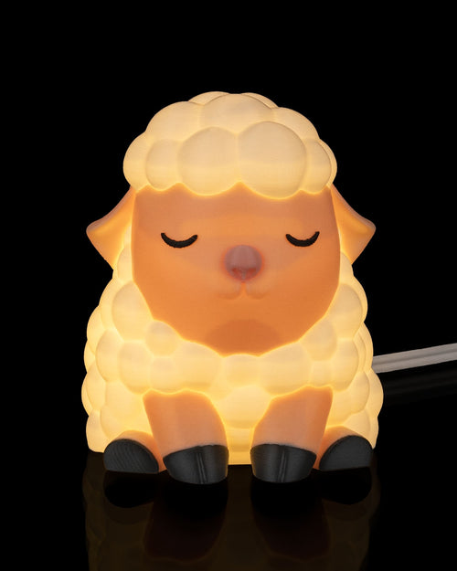 Sheep-shaped night light on a black background Counting sheep table lamp front view whimsical sheep night light home decor nursery kids babies baby children